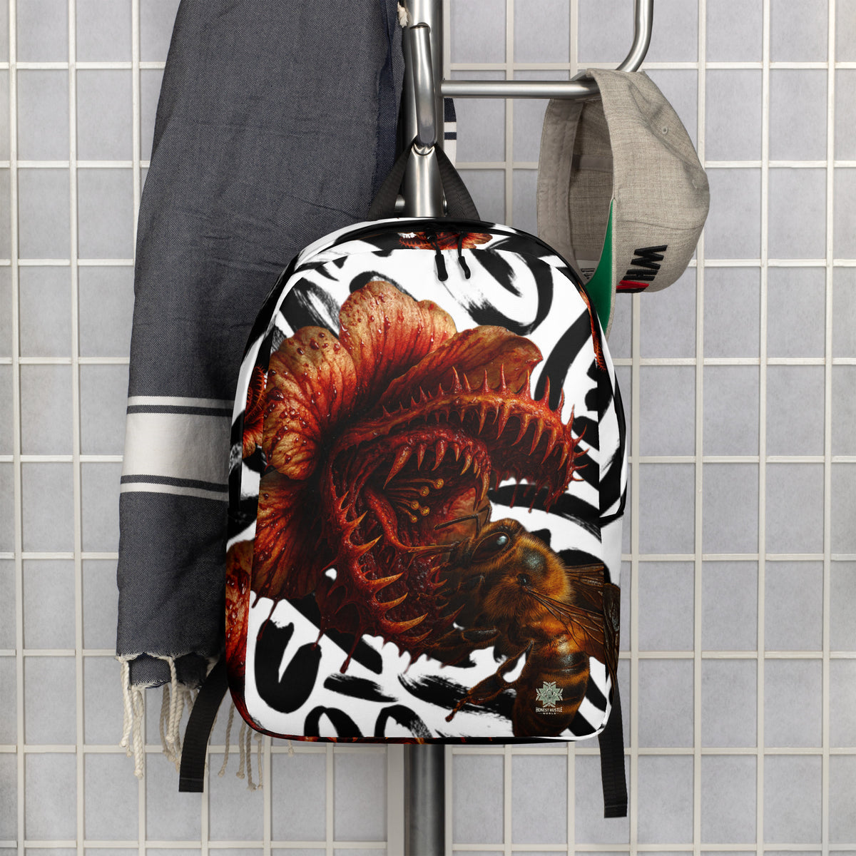 Backpack from Honest Hustle World — BLOOM Trap & Truth flower-and-bee graphic, back view